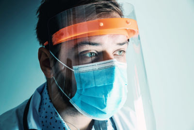 doctor treating COVID-19 wearing face-shield and mask - covid-19 concept